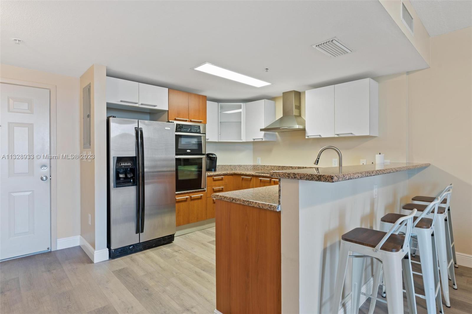170 Southeast 14th Street, Unit 1906 Miami, FL 33131 - Photo 8 of 26 a kitchen with stainless steel appliances granite countertop a refrigerator and a sink