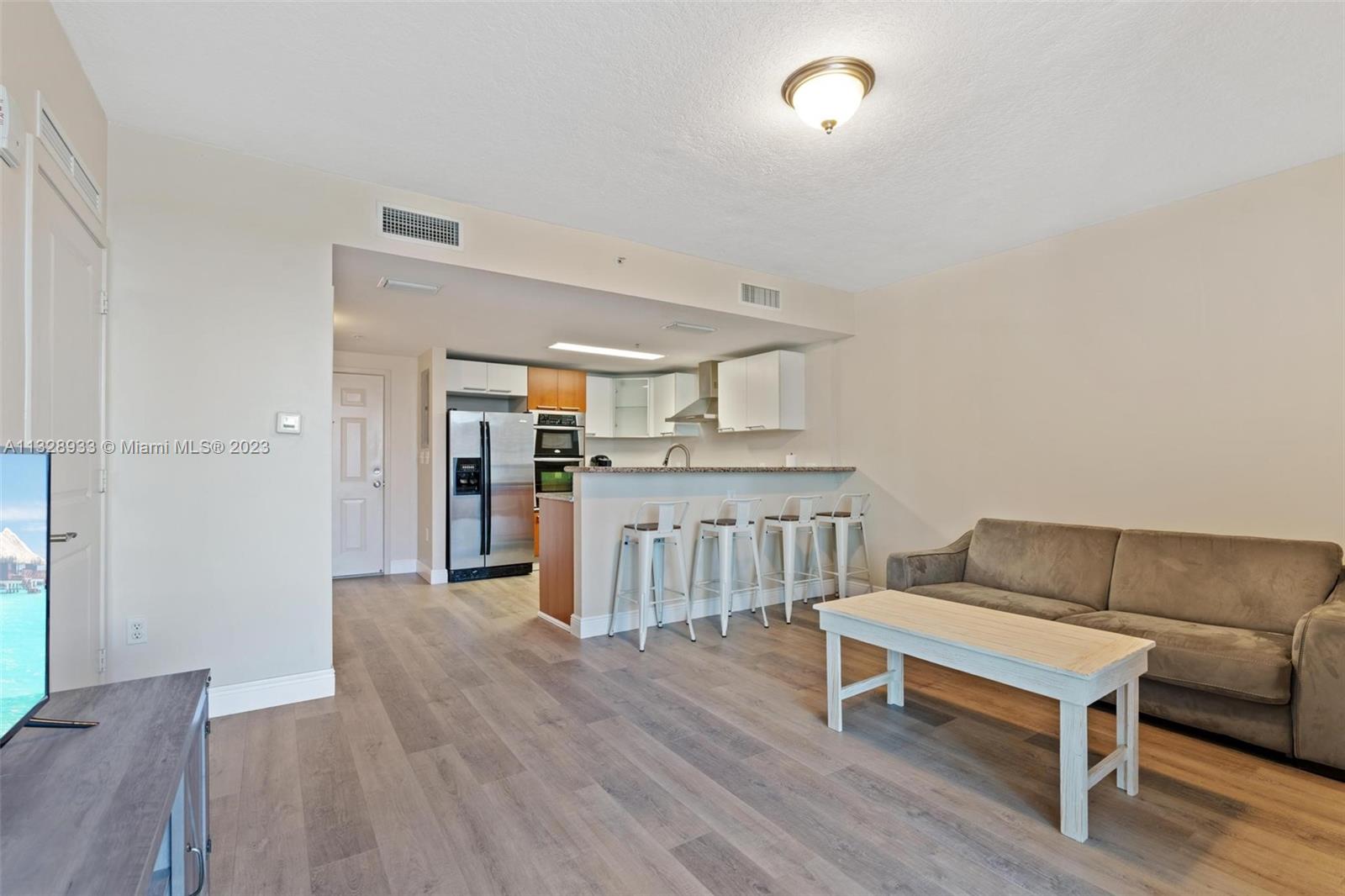 170 Southeast 14th Street, Unit 1906 Miami, FL 33131 - Photo 10 of 26 a living room with furniture a ceiling fan and wooden floor