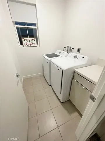 a view of a patio with couple of furniture and a grill