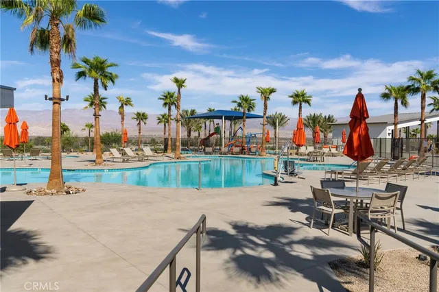 a view of swimming pool with seating area and furniture
