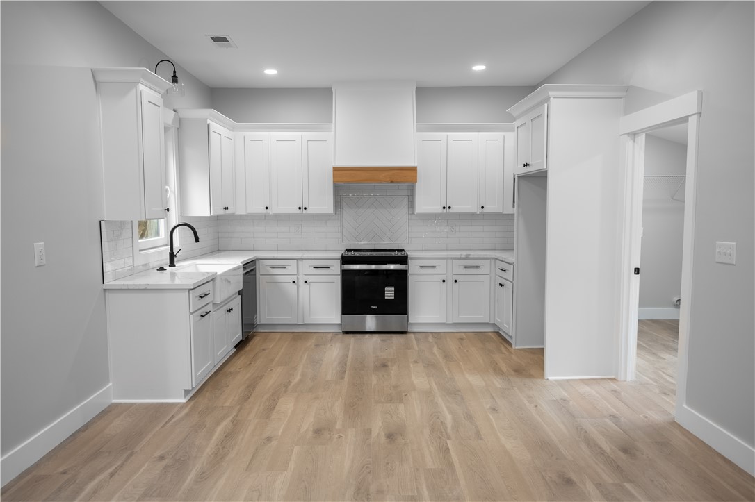 2817 Broadway Lake Road Anderson, SC 29621 - Photo 20 of 41 White cabinetry and light wood flooring define this contemporary culinary space.