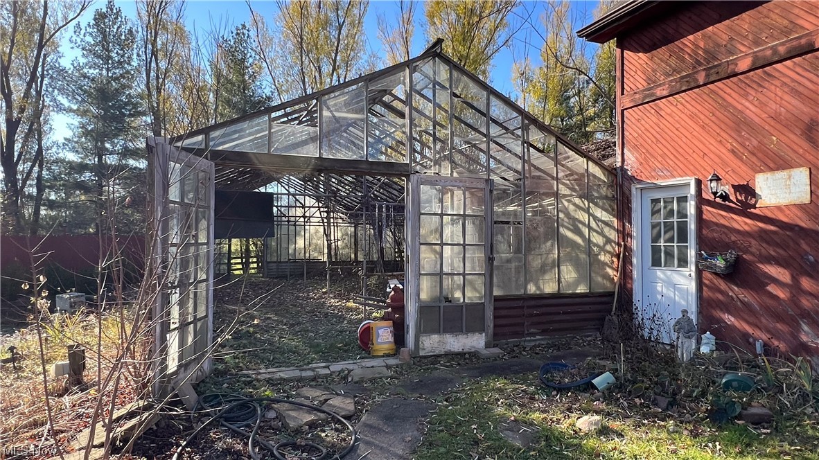 1148 Ridge Road Hinckley, OH 44233 - Photo 25 of 33 Greenhouse adjacent to garage in need of repair