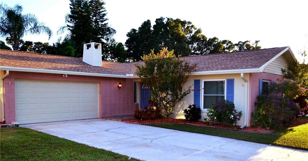 1965 Sourwood Boulevard Dunedin, FL 34698 - Photo 1 of 1 a house view with a garden space