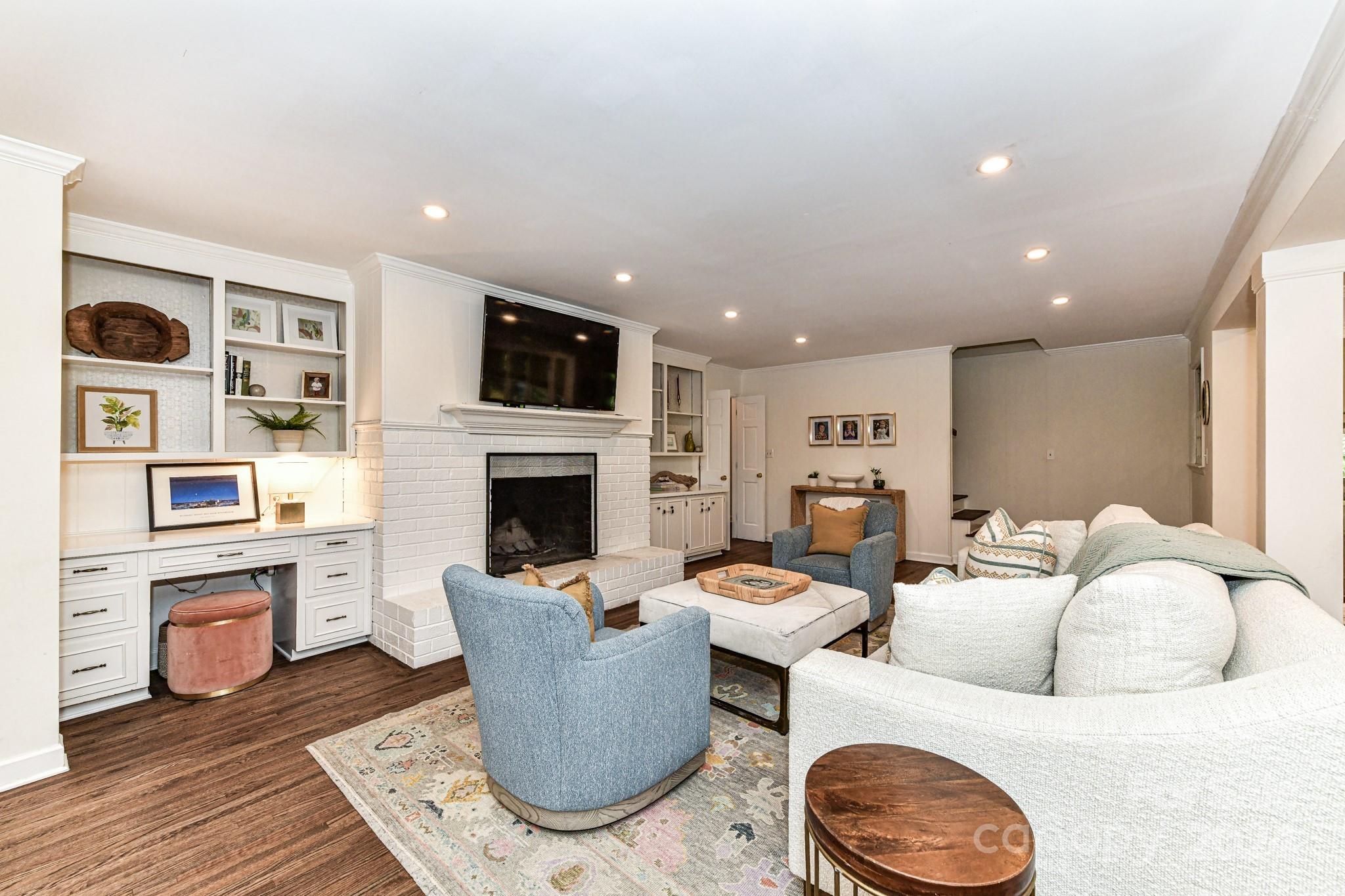 3026 Rustic Lane Charlotte, NC 28210 - Photo 17 of 39 a living room with furniture a fireplace and a flat screen tv