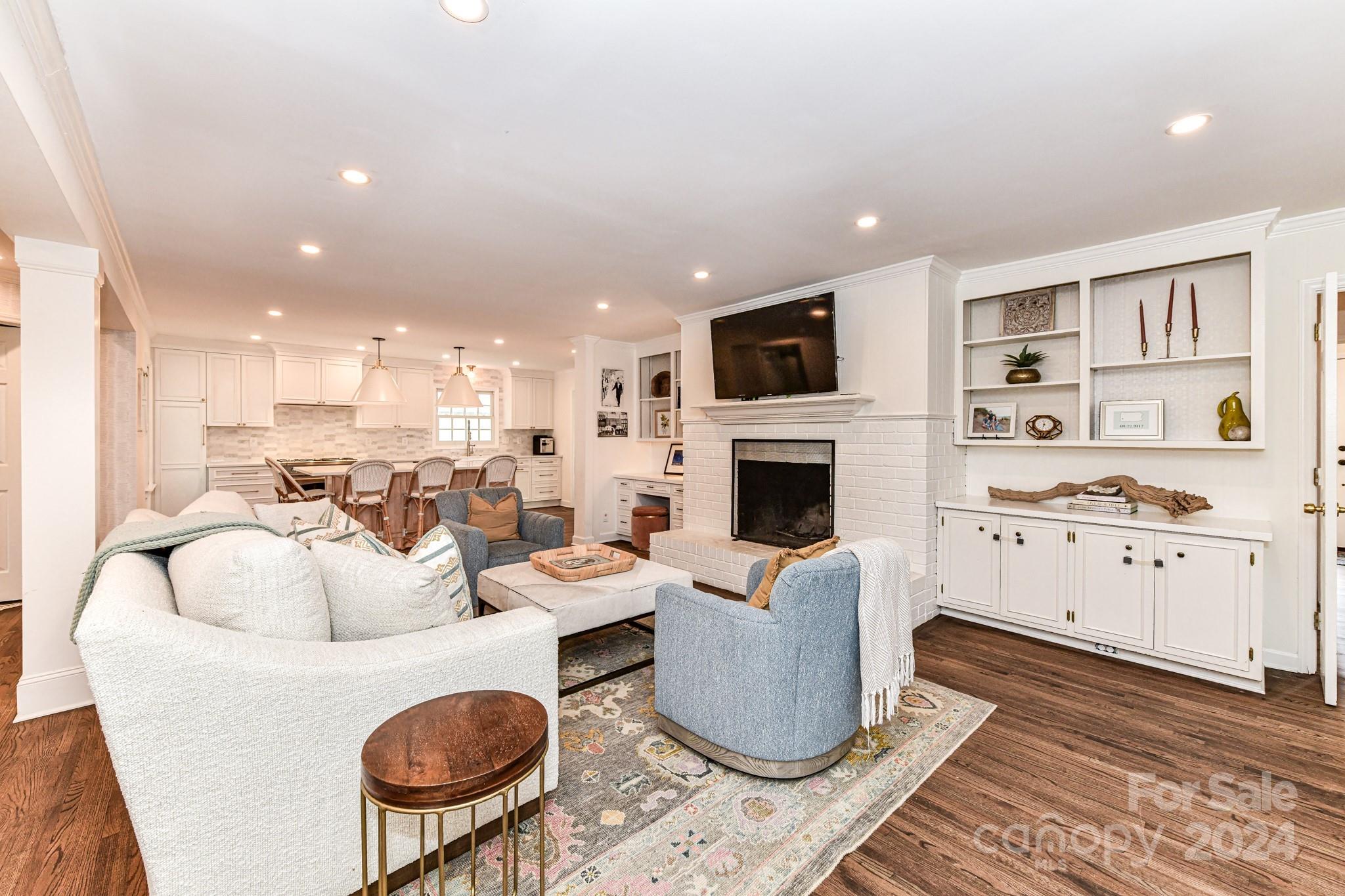 3026 Rustic Lane Charlotte, NC 28210 - Photo 18 of 39 a living room with furniture a fireplace and a flat screen tv