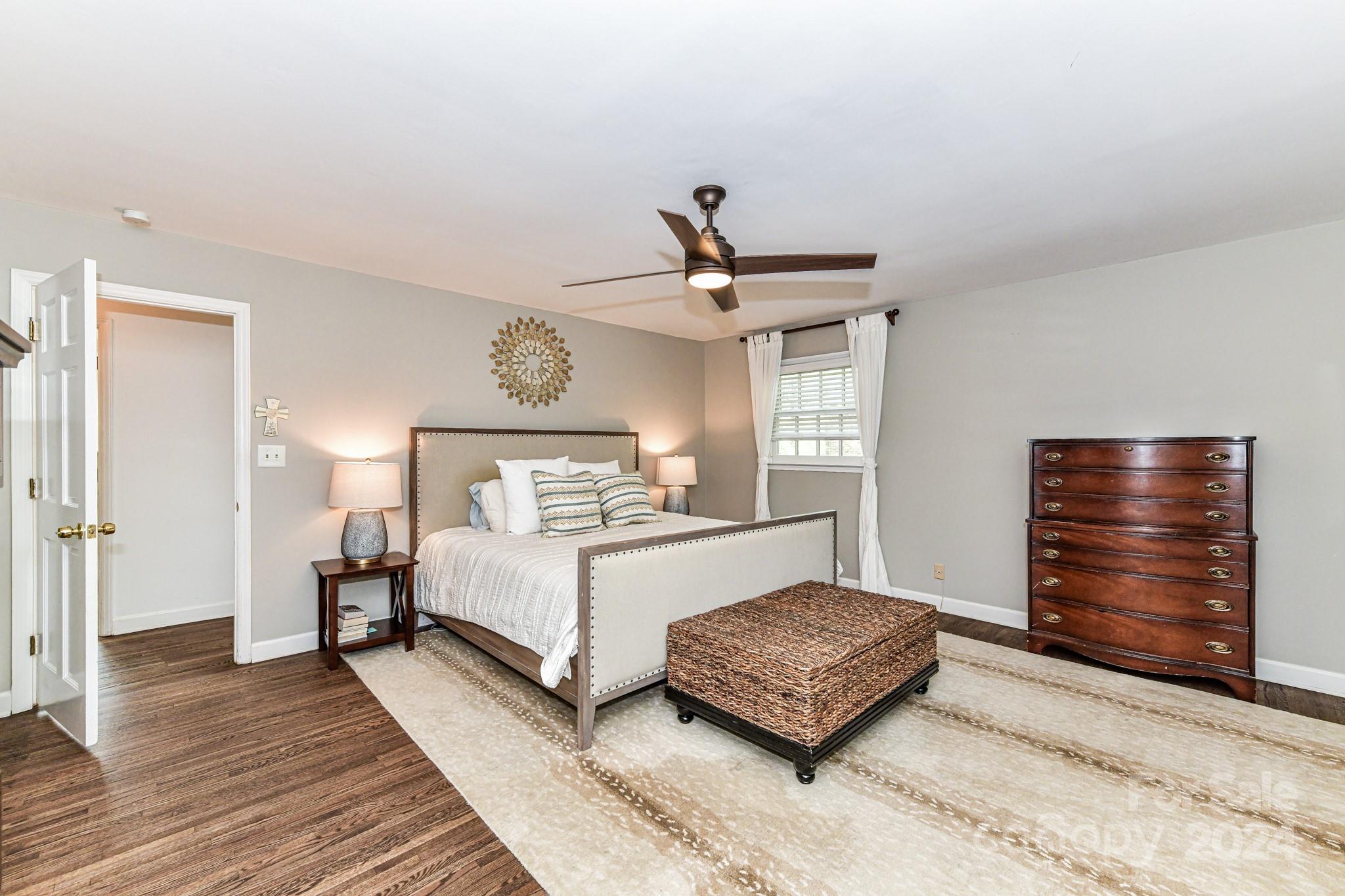 3026 Rustic Lane Charlotte, NC 28210 - Photo 20 of 39 a spacious bedroom with a bed and cabinet