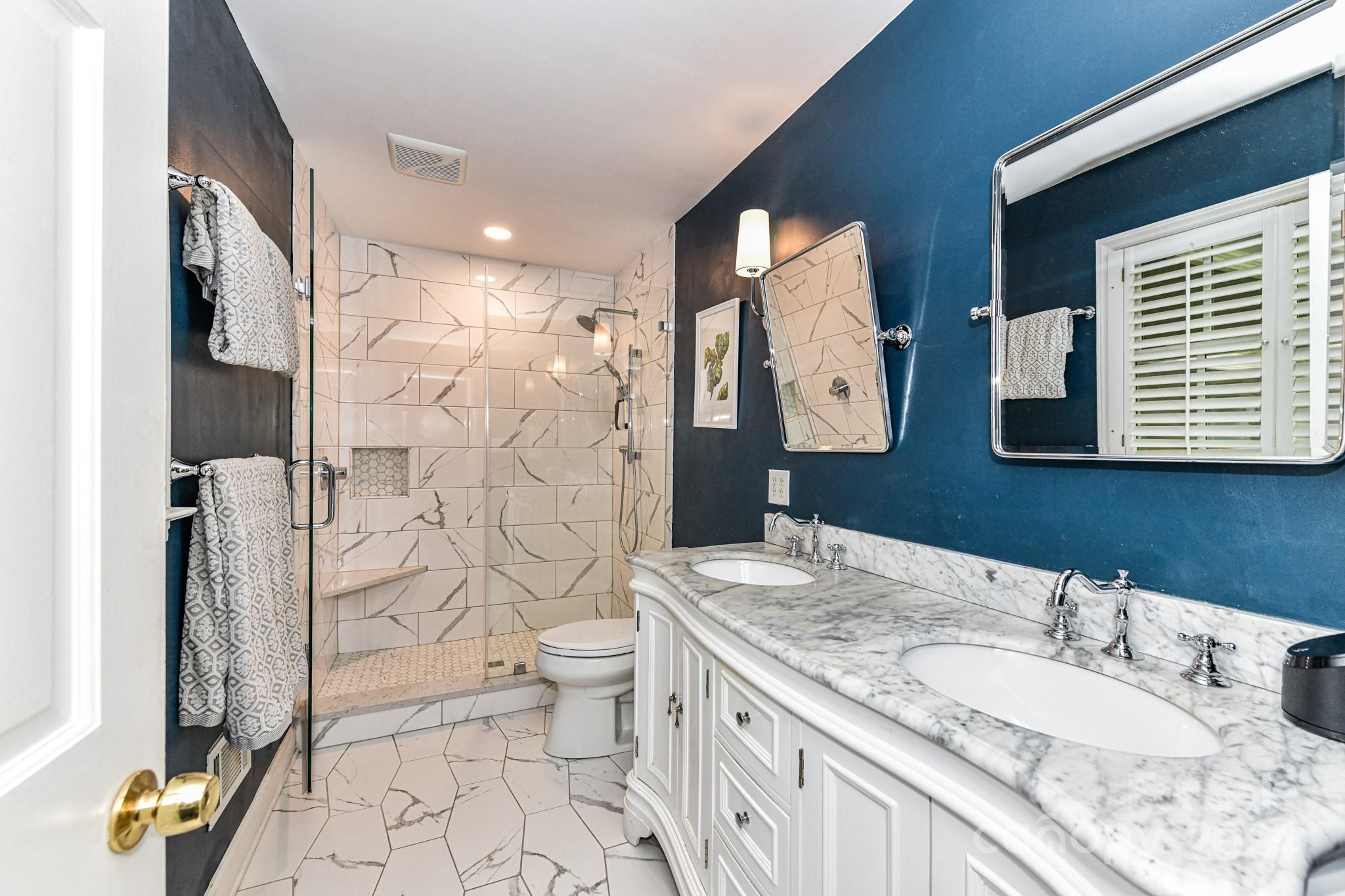 3026 Rustic Lane Charlotte, NC 28210 - Photo 22 of 39 a bathroom with a granite countertop sink toilet and shower
