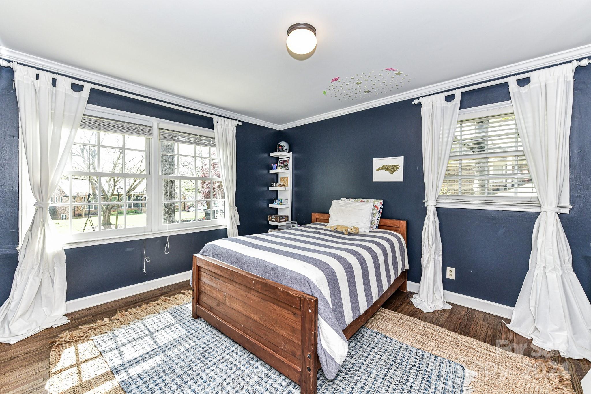 3026 Rustic Lane Charlotte, NC 28210 - Photo 23 of 39 a bedroom with a large bed and a window