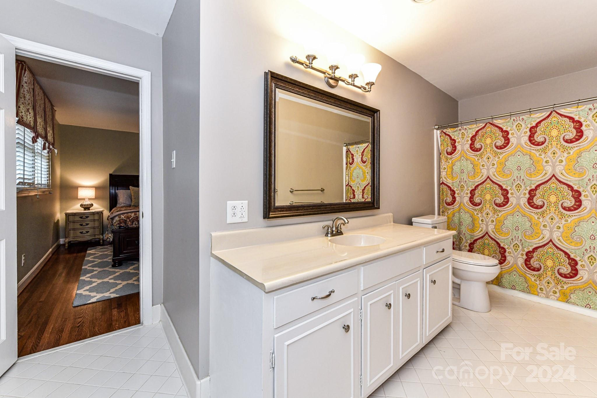 3026 Rustic Lane Charlotte, NC 28210 - Photo 29 of 39 a en suite bathroom with a double vanity sink and a mirror