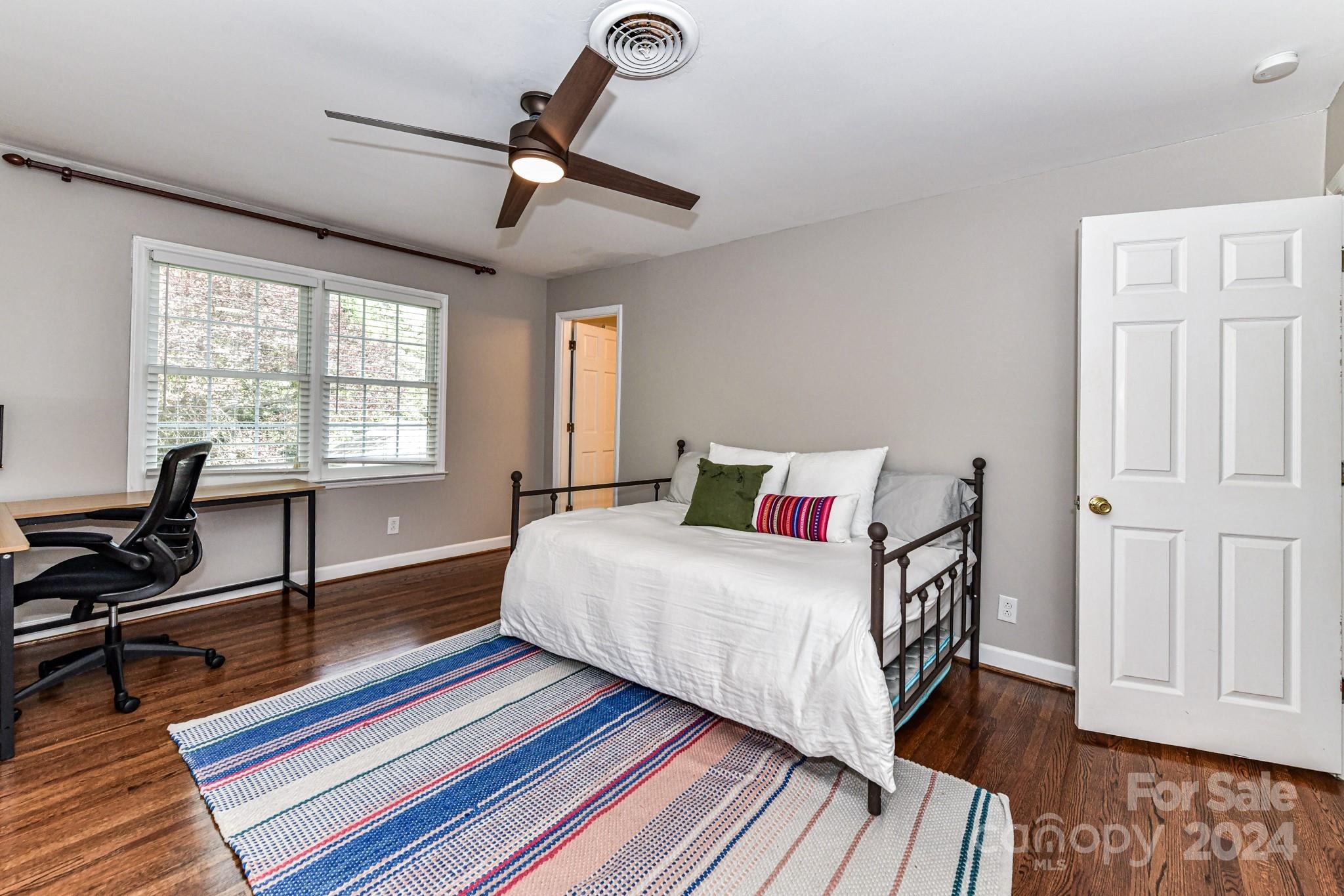 3026 Rustic Lane Charlotte, NC 28210 - Photo 30 of 39 a bedroom with a bed and a wooden floor