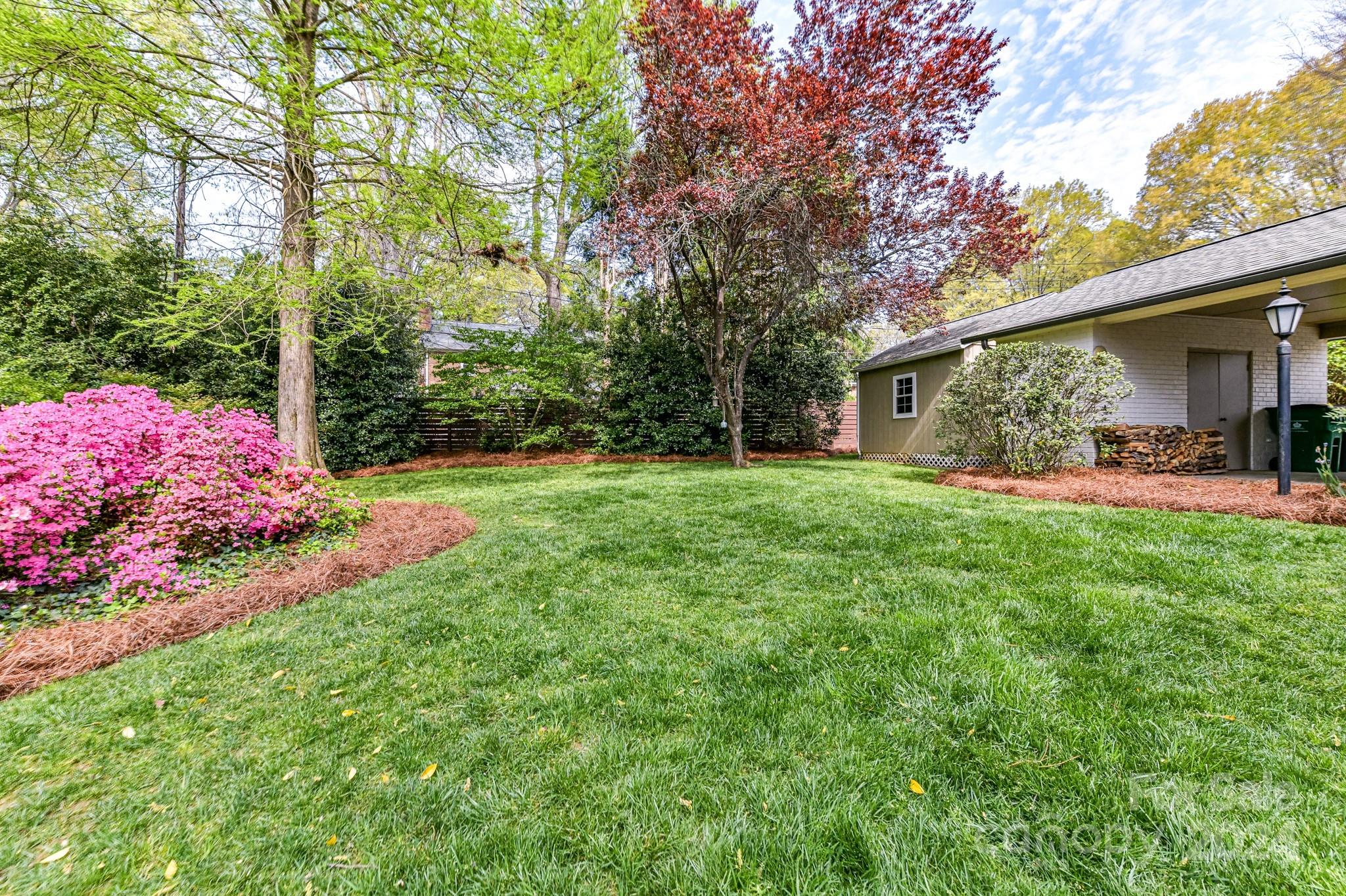 3026 Rustic Lane Charlotte, NC 28210 - Photo 37 of 39 a front view of a house with garden and trees