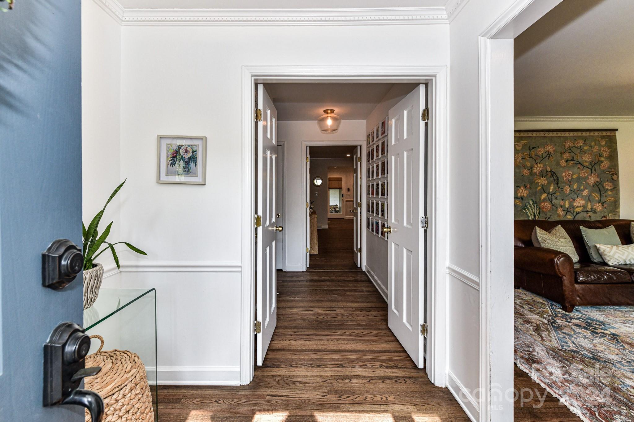 3026 Rustic Lane Charlotte, NC 28210 - Photo 4 of 39 a view of a hallway to a livingroom with wooden floor and furniture