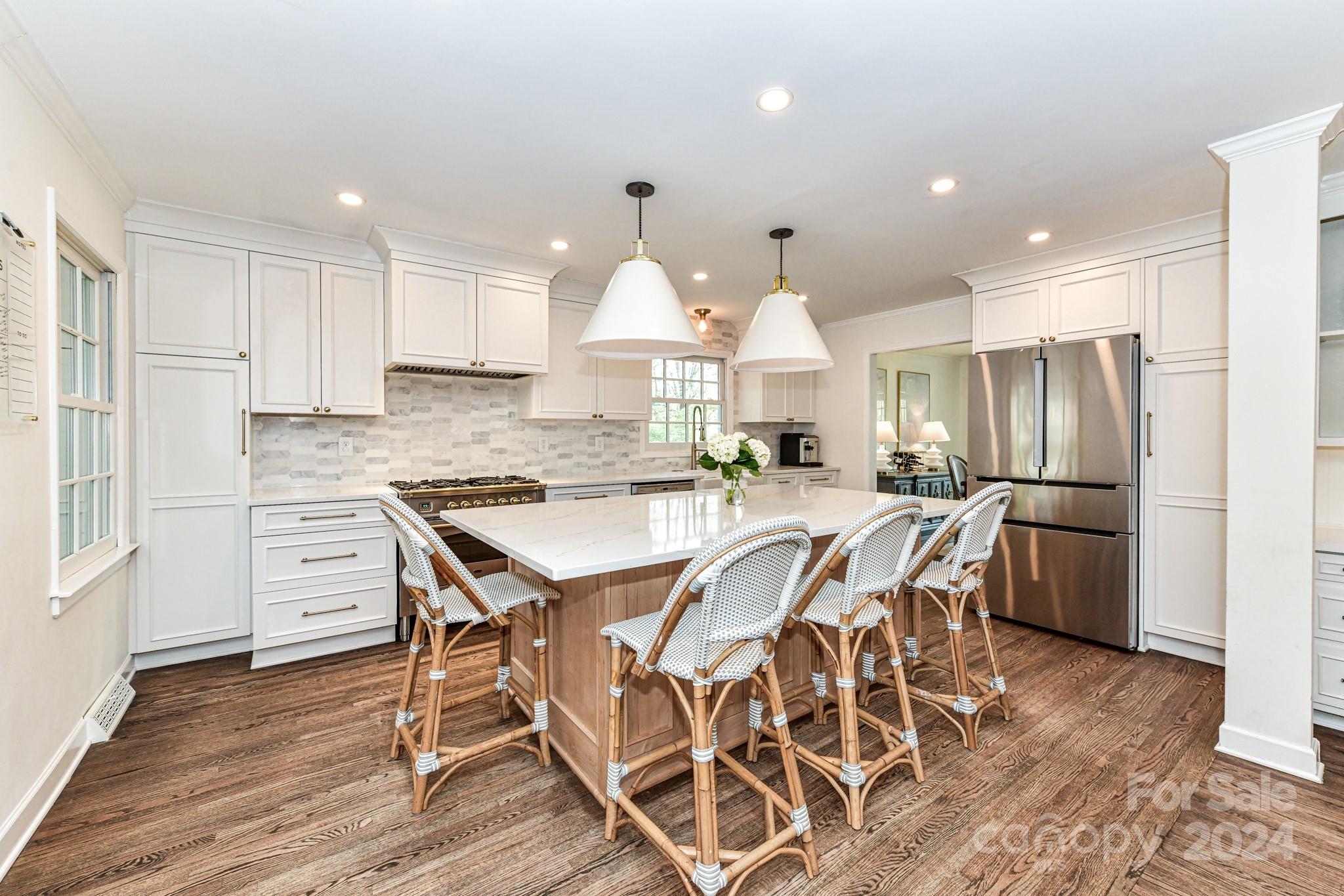 3026 Rustic Lane Charlotte, NC 28210 - Photo 10 of 39 a kitchen with stainless steel appliances kitchen island granite countertop a table chairs sink and cabinets