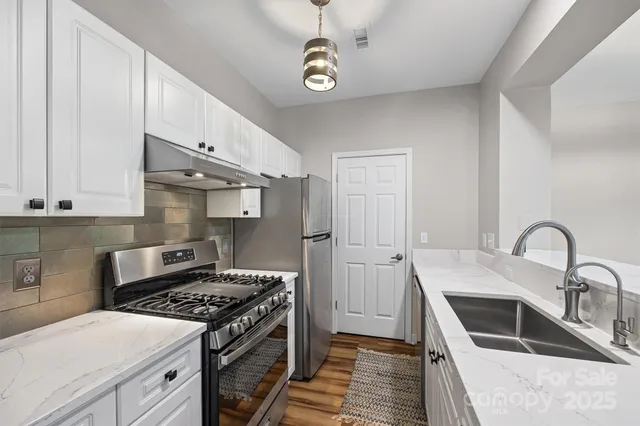 a kitchen with a stove and a sink