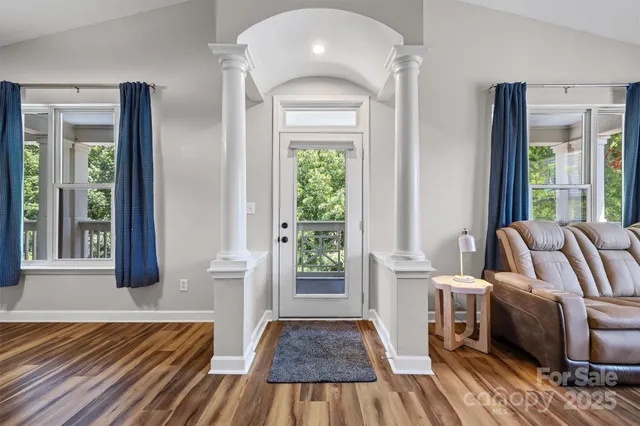 a view of a bedroom with furniture and windows