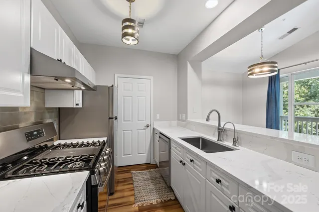 a kitchen with a sink stove and cabinets