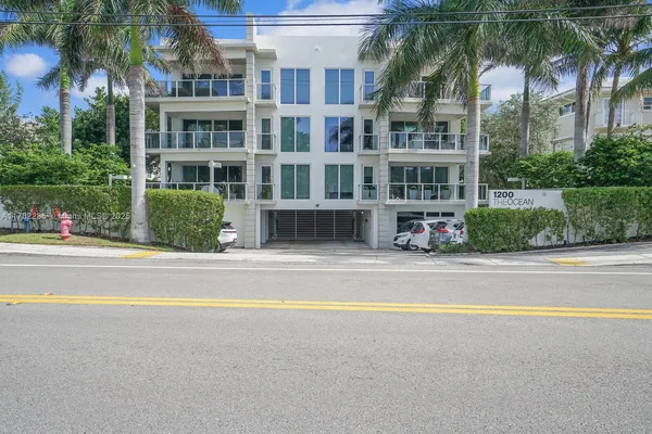 a view of houses with palm trees