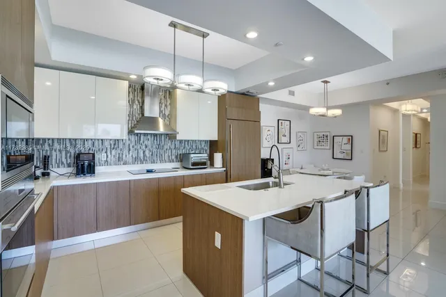 a kitchen with a center island appliances and cabinets