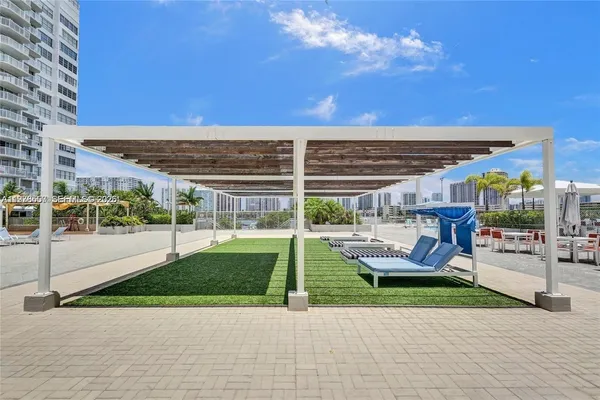 a view of swimming pool is middle in back of a building