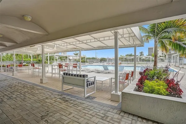 a view of a swimming pool and lounge chairs