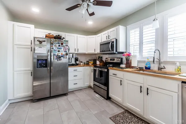 a kitchen with a sink stove and microwave