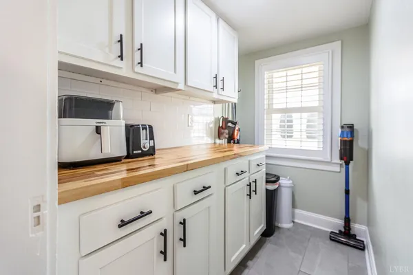 a bathroom with a granite countertop toilet sink and mirror
