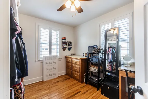 a view of an empty room with a window and a cabinet