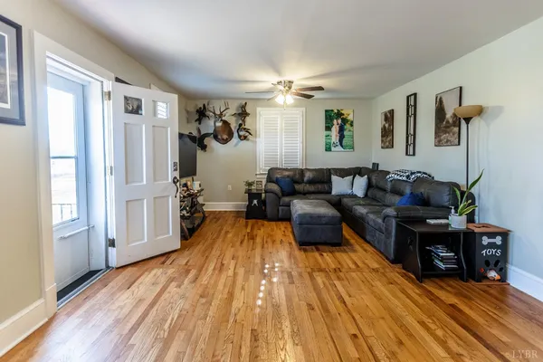 a living room with furniture and a wooden floor