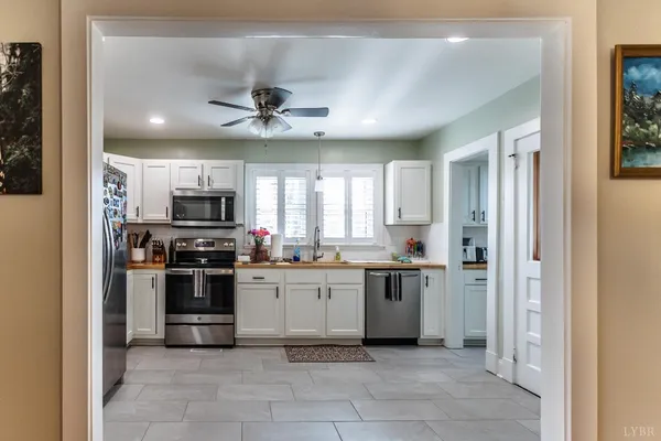 a kitchen with stainless steel appliances a stove sink microwave and cabinets