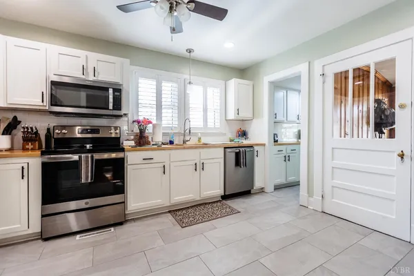 a kitchen with stainless steel appliances a refrigerator sink and microwave