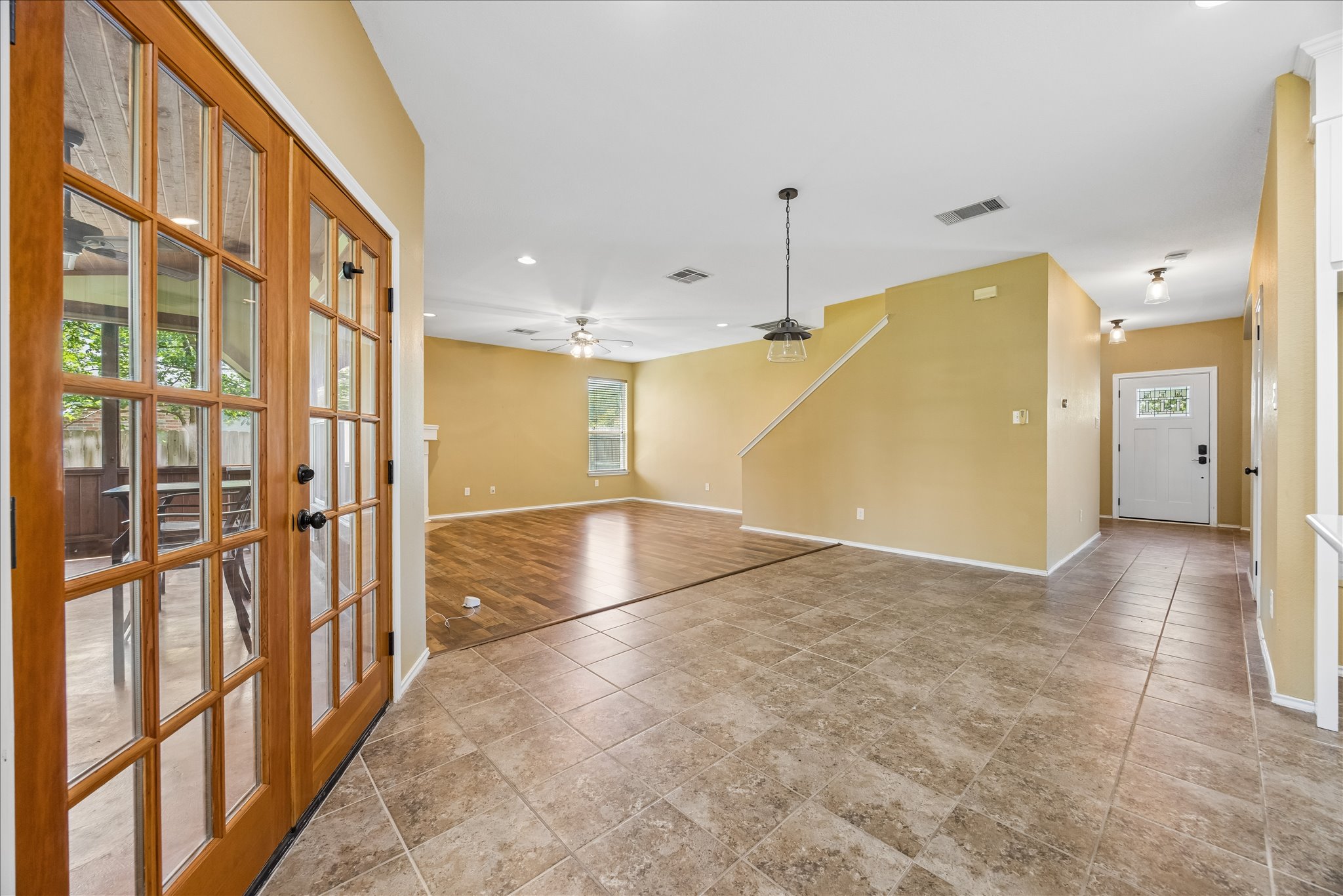 338 Spring Branch Loop Kyle, TX 78640 - Photo 10 of 36 A versatile open-plan interior with a blend of resilient tile and rich wood flooring.