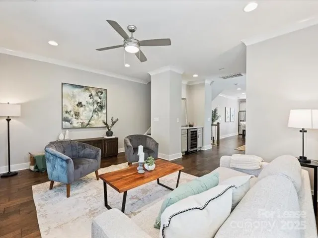 a living room with furniture a rug and a lamp