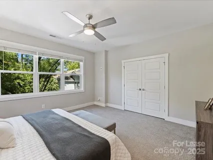 a bed room with a bed and a large window