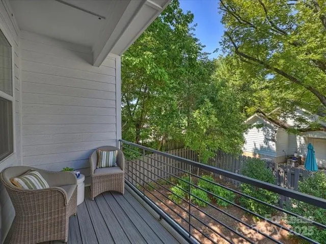 a view of balcony with wooden floor and seating space