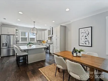 a kitchen with a table and chairs in it