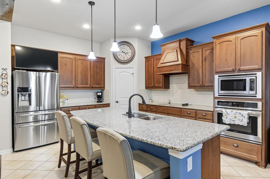 142 High Ridge Court Decatur, TX 76234 - Photo 11 of 40 a kitchen with stainless steel appliances granite countertop a sink refrigerator and microwave