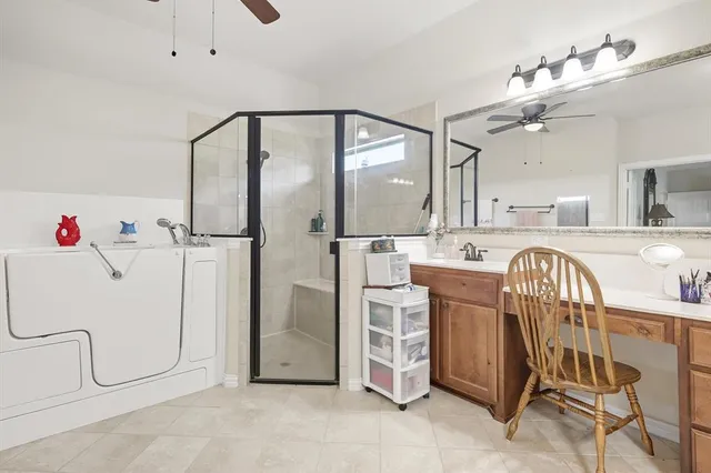 a spacious bathroom with a tub sink and mirror