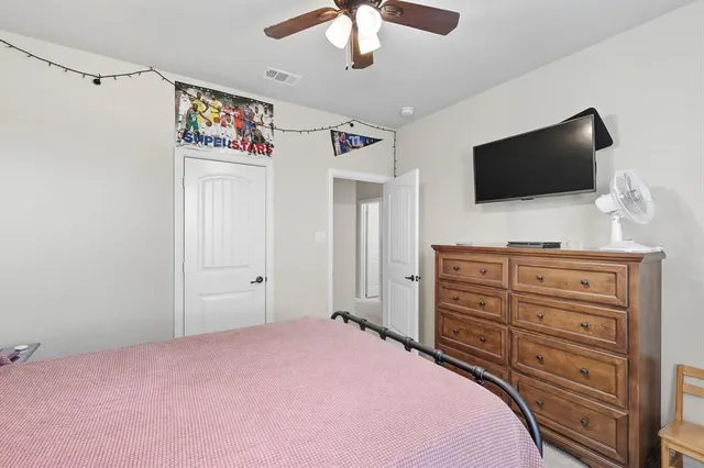 a bedroom with a bed and a flat screen tv