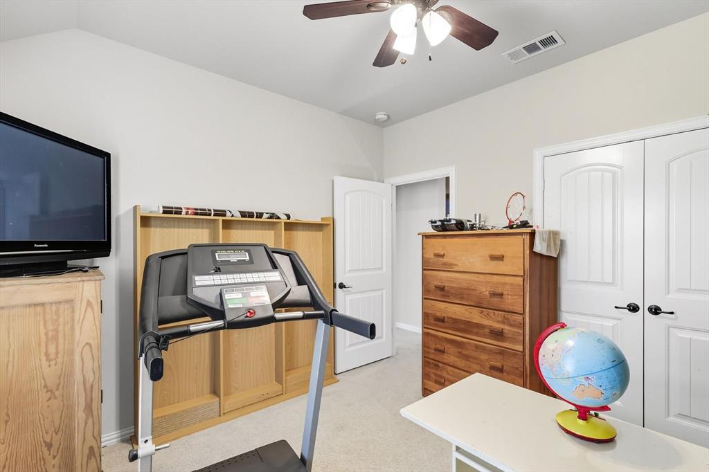 142 High Ridge Court Decatur, TX 76234 - Photo 24 of 40 a bedroom with a bed and wooden floor