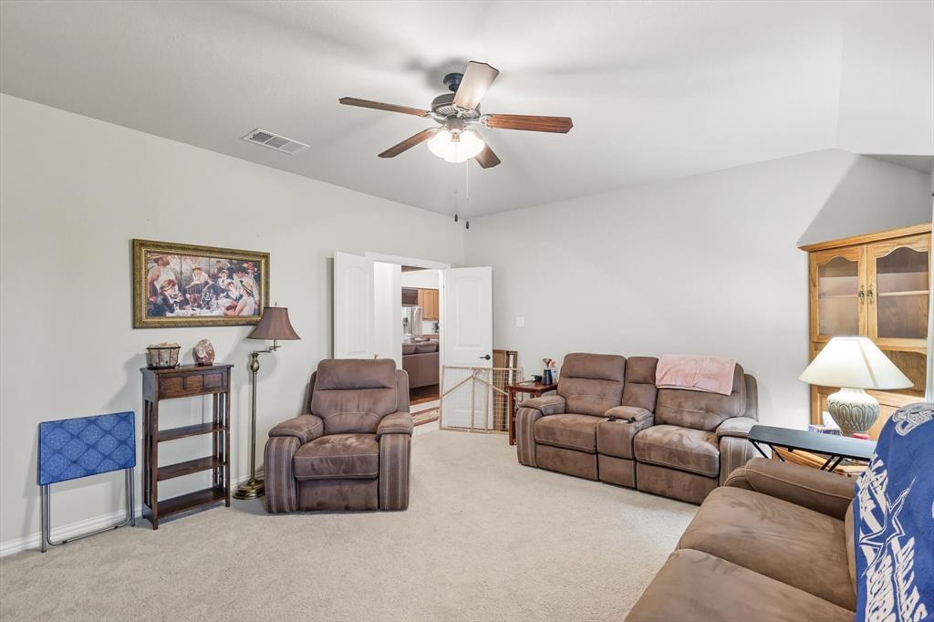 142 High Ridge Court Decatur, TX 76234 - Photo 26 of 40 a living room with furniture and a ceiling fan