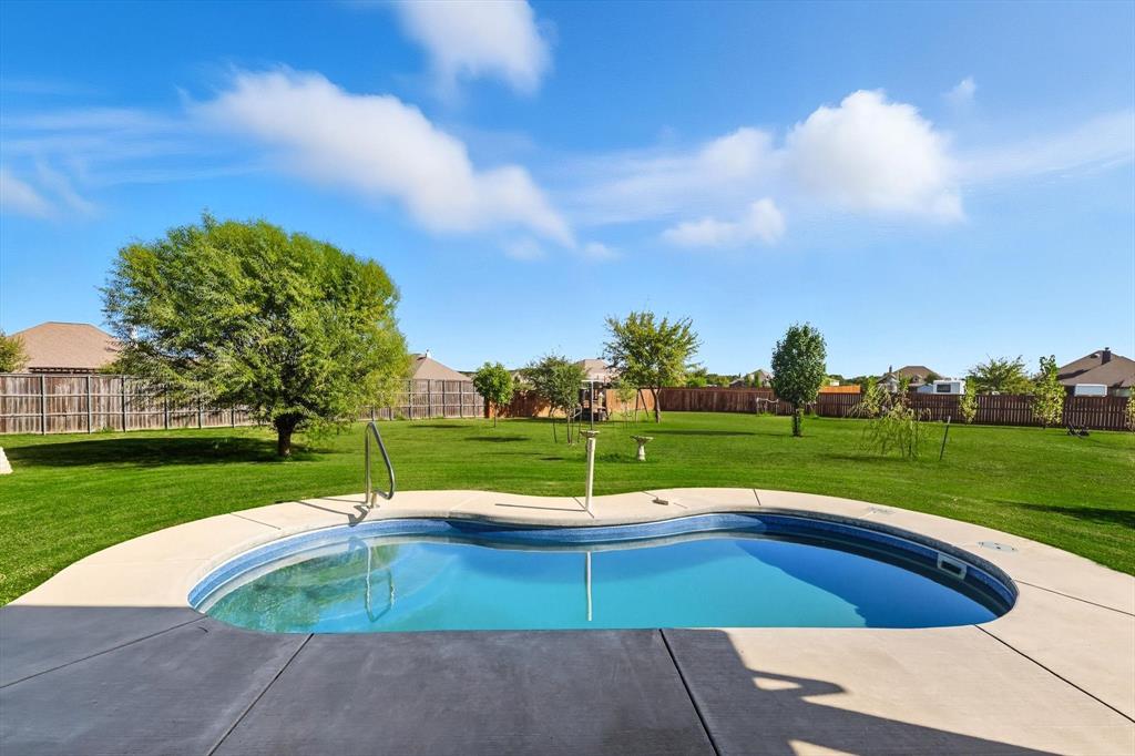 142 High Ridge Court Decatur, TX 76234 - Photo 29 of 40 a view of a swimming pool with a yard