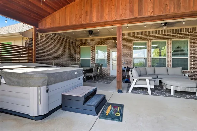 a view of a patio with table and chairs