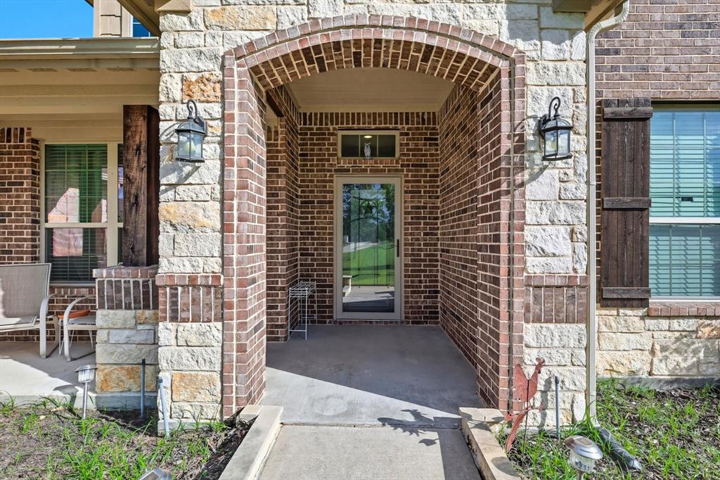 142 High Ridge Court Decatur, TX 76234 - Photo 4 of 40 a front view of a house with outdoor seating