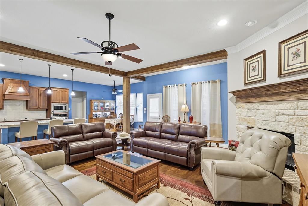 142 High Ridge Court Decatur, TX 76234 - Photo 7 of 40 a living room with furniture ceiling fan and a fireplace