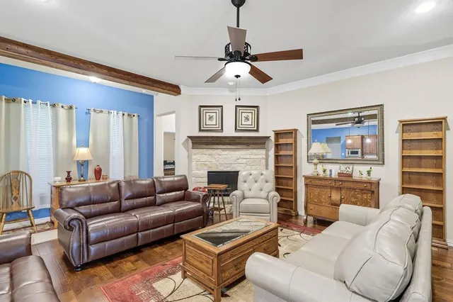 a living room with furniture a large window and a fireplace