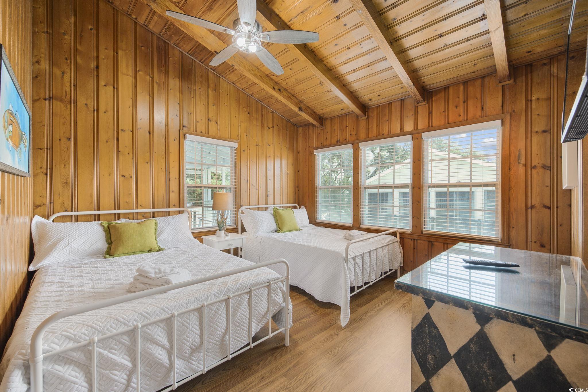 222 Calhoun Drive Murrells Inlet, SC 29576 - Photo 17 of 40 Bedroom with hardwood / wood-style floors, multiple windows, and wood walls