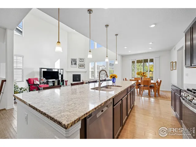 a kitchen with kitchen island a large counter top space appliances and living room view