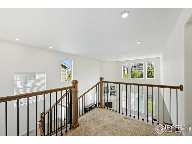 a spacious bedroom with a bed a window and a television