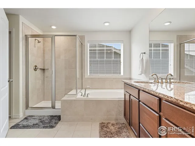 a en suite bathroom with a granite countertop sink and a mirror
