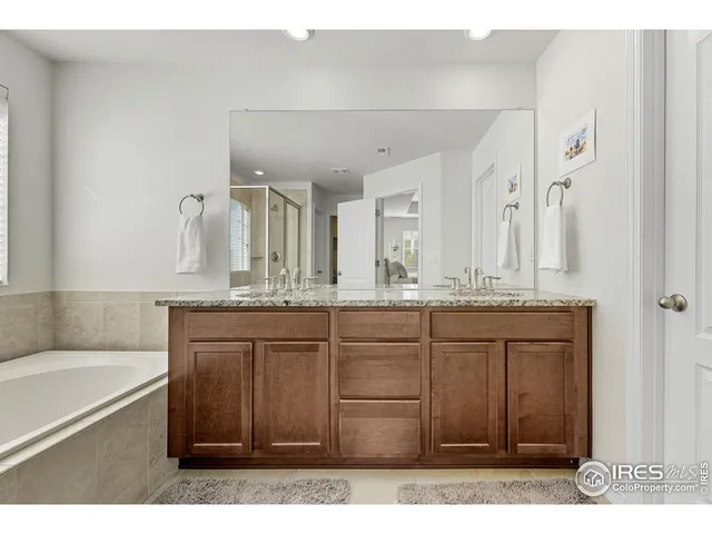 a spacious bedroom with a bed and a window